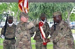 Lt. Col. Robert Jarzyna (left)and Sgt. Maj. Greg Dorsey (right) furl the 916th Contracting Battalion organizational colors as Soldiers from the unit's color guard look on during an inactivation ceremony at Joint Base San Antonio-Fort Sam Houston May 15. The inactivation of the battalion is a result of force structure changes directed by the secretary of the Army to adapt the service's force generation process to the needs of a contingency force. Jarzyna served as commander of the 916th CBN and Dorsey served as the battalion sergeant major. 
