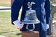 A Joint Base Color Guard member rings a bell during the Department of Defense Fallen Firefighter Memorial on Goodfellow Air Force Base, Texas, May 12, 2017. The bell is rang four rings, five times, marking the end of the watch for the firefighters. (U.S. Air Force photo by Staff Sgt. Joshua Edwards/Released)