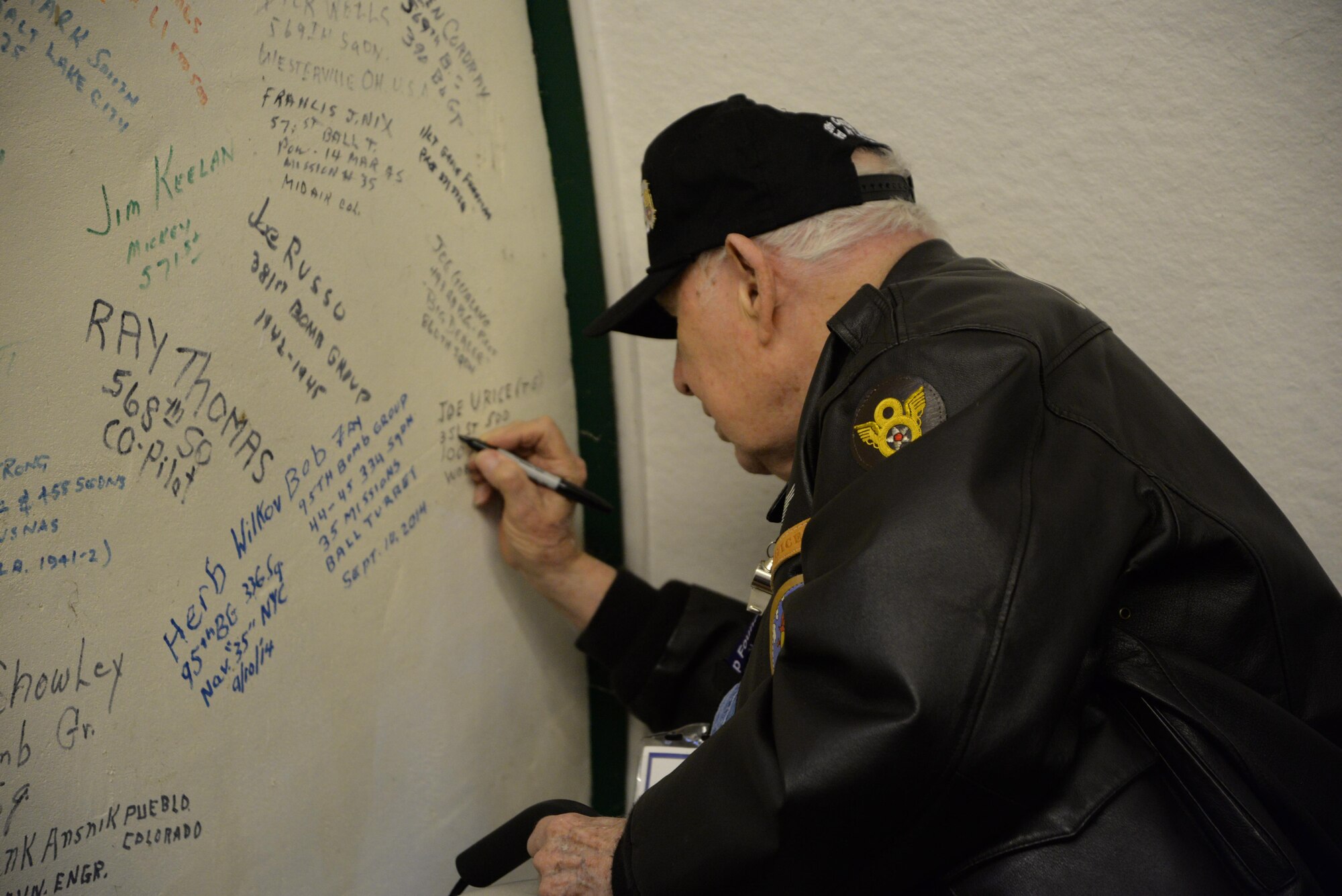 Staff Sgt. (retired) Joe Urice, 100th Bombardment Group (Heavy) veteran and former B-17 tailgunner, signs his name on the “Heroes Wall of Fame” May 10, 2017, at Parham Airfield Museum, England. The museum is one of many around East Anglia dedicated to the men who served during World War II.  Veterans of the 100th BG and their families, along with Team Mildenhall members, spent the day visiting former East Anglian bases in Horham, Parham and Thorpe Abbots. The 100th BGF members also visited RAF Mildenhall, Madingley American Cemetery and Duxford War Museum during their trip to celebrate the 100th BG’s 75th anniversary. (U.S. Air Force photo by Karen Abeyasekere)