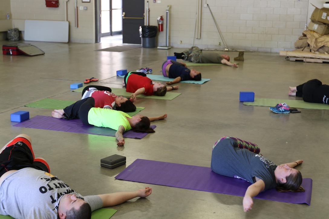 Members of the 103rd Sustainment Command (Expeditionary) participate in a Yoga session with Olivia Kvitne on May 12, 2017 at Fort Des Moines, Iowa.  Kvitne is founder of Yoga for First Responders which focuses on providing Yoga as a tool to relieve stress for veterans and those who have experienced post-traumatic stress disorder.  (Released/U.S. Army photo by Capt. Charles An)