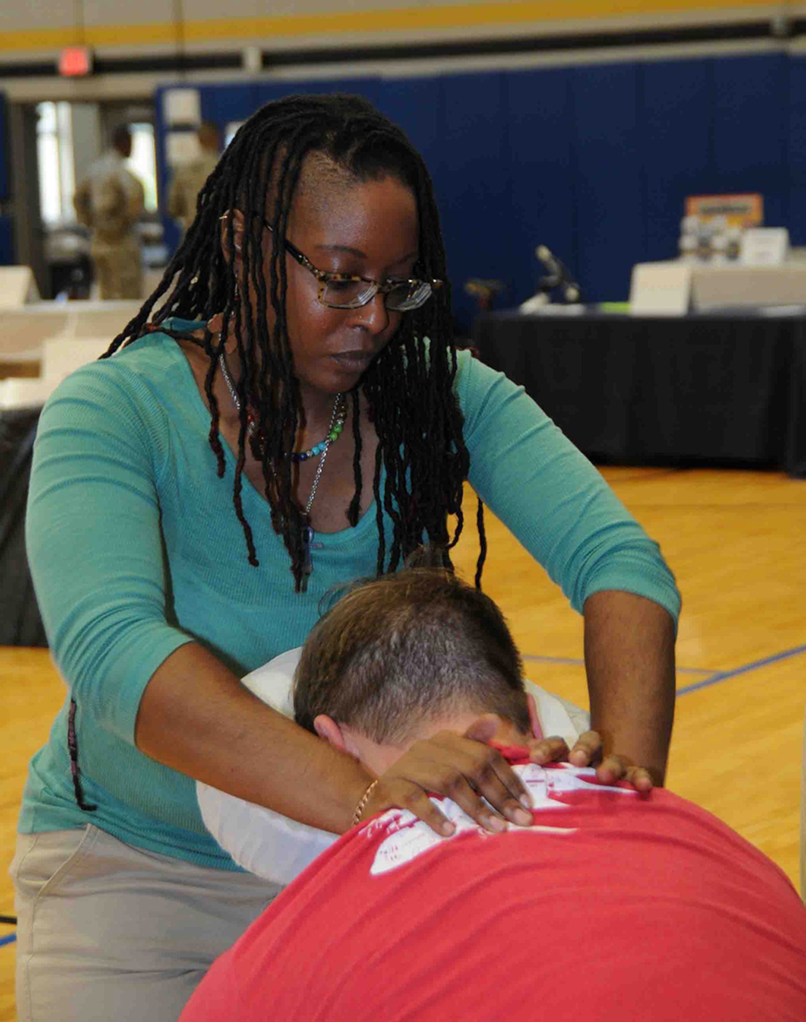 Chaun Walker, masseuse, demonstrates the benefits of massage therapy to an Airman at the May Health Fair May 6, at the Dobbins Air Reserve Base Fitness Center, Dobbins Air Reserve Base, Georgia. This illustrates an outlet for physical stress as part of mental, physical and spiritual well-being which was the fair's focus.(U.S. Air Force photo by Airman First Class Justin Clayvon)