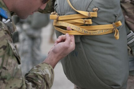 U.S. Army Cpt. Anthony Menas, with West Virginia Army National Guard 2nd Battalion, 19th Special Forces Group, performs parachute inspections for a static-line jump from a C-130 aircraft on Saturday, March 13, 2017, during the Wings Over Pittsburgh Open House. Soldiers teamed up with the 911th Airlift Wing and the 758th Aviation Squadron in Coraopolis, Pennsylvania. for the two-day event held over Mother's Day weekend. (U.S. Army photo by Staff Sgt. Shaiyla Hakeem/Released).