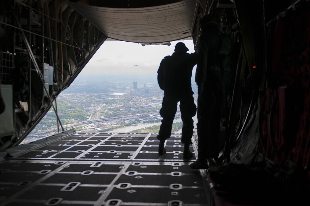 U.S. Air Force Command Master Sgt. Archie Branton, loadmaster with 911th Air Wing, 758th Airlift Squadron, watches on the back ramp of a C-130 aircraft as Soldiers parachute on Saturday, March 13, 2017, during the Wings Over Pittsburgh Open House.  The West Virginia Army National Guard's 19th Special Forces Group paired with the Air Force for the two-day event. (U.S. Army photo by Staff Sgt. Shaiyla Hakeem/Released).