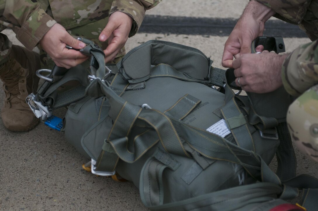 U.S. Army West Virginia National Guard Soldiers, of 2nd Battalion, 19th Special Forces Group, prepares their parachute gear for a static-line jump from a C-130 aircraft Saturday, March 13, 2017, during the Wings over Pittsburgh Open House. The event was hosted by the 911th Air Wing, 758th Aviation Squadron and was collaboration with the Air Force Reserve, Army National Guard, Army Reserve and the Navy Reserve. (U.S. Army photo by Staff Sgt. Shaiyla Hakeem/Released)