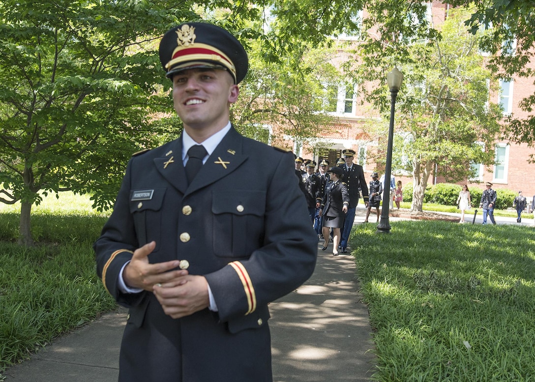 Brand new U.S. Army 2nd Lt. Allen Robertson walks across the Clemson University campus to propose to his girlfriend, Chelsea Campbell, after his Reserve Officers’ Training Corps commissioning ceremony, May 10, 2017. The two met while they were students at Clemson and will both graduate this week. Robertson, who hails from Mooresville, N.C., earned a degree in accounting at Clemson and his first duty station will be with at Fort Campbell, Ky. with the 101st Airborne Division. Campbell, of Fort Mill, S.C., earned her degree in psychology. (U.S. Army Reserve photo by Staff Sgt. Ken Scar)