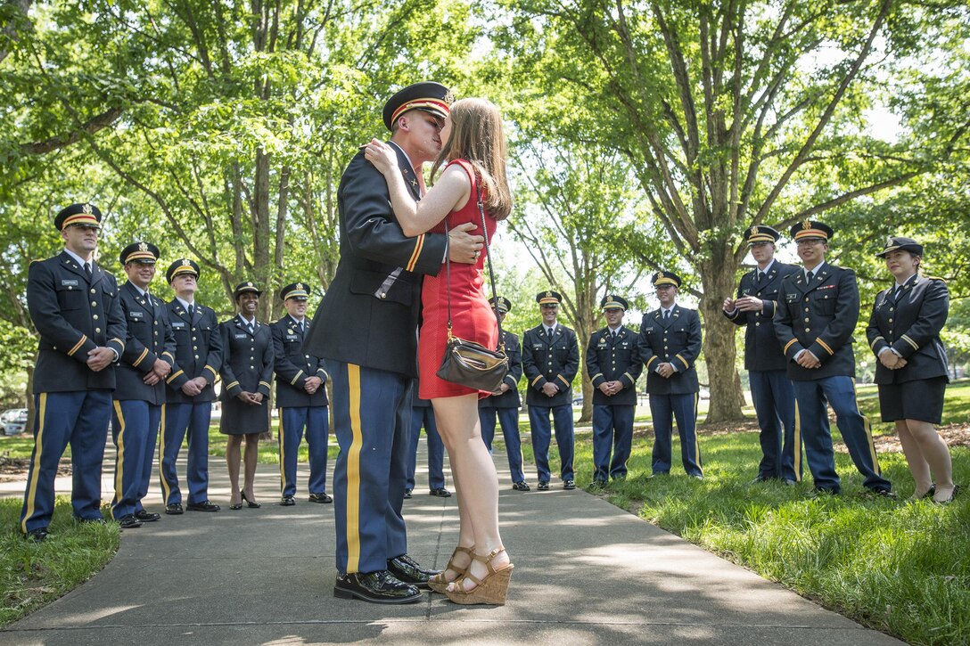 Brand new U.S. Army 2nd Lt. Allen Robertson kisses his fiance, Chelsea Campbell, after proposing to her immediately after his Clemson University Reserve Officers’ Training Corps commissioning ceremony, May 10, 2017. The two met while they were students at Clemson and will both graduate this week. Robertson, who hails from Mooresville, N.C., earned a degree in accounting at Clemson and his first duty station will be with at Fort Campbell, Ky. with the 101st Airborne Division. Campbell, of Fort Mill, S.C., earned her degree in psychology. (U.S. Army Reserve photo by Staff Sgt. Ken Scar)