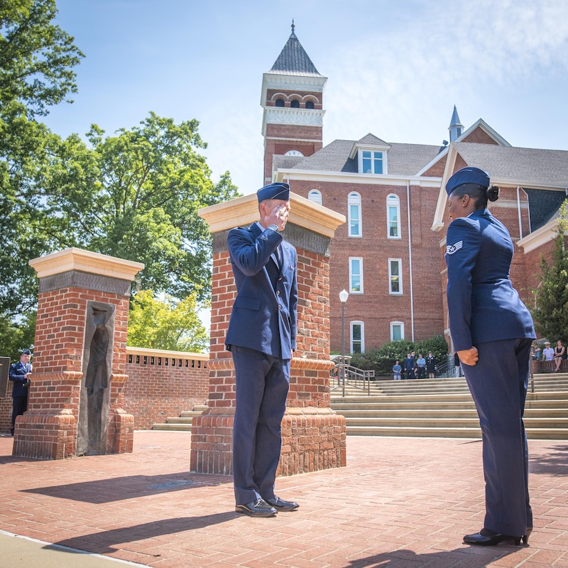 Newly-commissioned U.S. Air Force 2nd Lt. Sean Mac Lain (left) recieves his first salute during a Silver Dollar Ceremony after the Clemson University Reserve Officers’ Training Corps commissioning ceremony, May 10, 2017. Mac Lain was a member of both the 2016 Clemson football National Championship team and the Clemson Pershing Rifles 2016 National Champion drill and ceremony squad. (U.S. Army Reserve photo by Staff Sgt. Ken Scar)