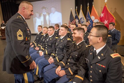 U.S. Army Master Sgt. Shane Werst, of Lake Forest, Cali., the senior military leadership instructor for Clemson University’s Reserve Officers’ Training Corps program, shares a moment with 26 very-soon-to-be second lieutenants before their commissioning ceremony, May 10, 2017 (U.S. Army Reserve photo by Staff Sgt. Ken Scar)