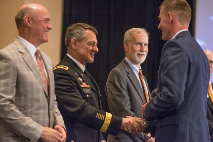 U.S. Army Maj. Gen. James B. Linder, commander of the U.S. Army John F. Kennedy Special Warfare Command, congratulates brand new 2nd Lt. Sean Mac Lain during Clemson University’s Reserve Officers’ Training Corps commissioning ceremony, May 10, 2017. Mac Lain was a member of both the 2016 Clemson Tigers National Football Championship team and the Clemson ROTC Pershing Rifles 2016 national champion drill and ceremony team. (U.S. Army Reserve photo by Staff Sgt. Ken Scar)