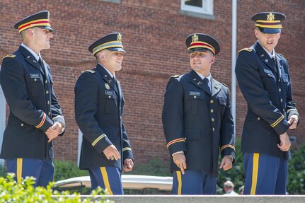 Brand new U.S. Army 2nd Lt. Allen Robertson (second from right) hobnobs with three of his fellow Clemson University Reserve Officers’ Training Corps graduates as they wait to receive their first salutes in a Silver Dollar Ceremony, May 10, 2017.  (U.S. Army Reserve photo by Staff Sgt. Ken Scar)