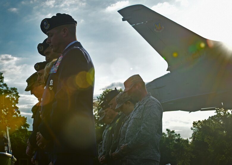 Attendees bow their heads during the National Police Week opening ceremony at Joint Base Langley-Eustis, Va., May 15, 2017. Police Week memorializes law enforcement officers who laid down their lives in service to the nation. (U.S. Air Force photo/Staff Sgt. Areca T. Bell)