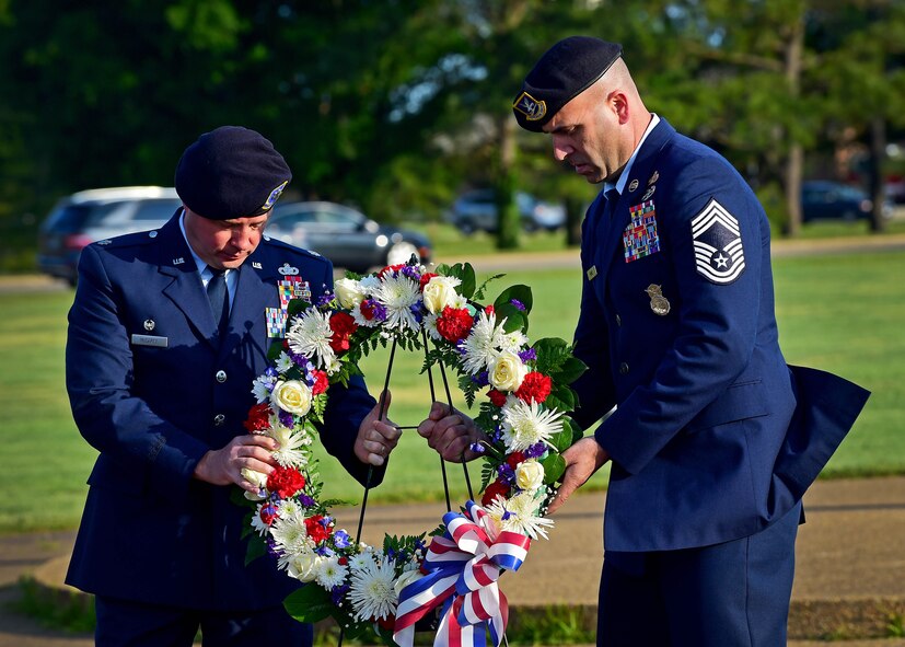 Lt. Col. Timothy McCarty, 633rd Security Forces Squadron commander, and Chief Master Sgt. Kevin Range, 633rd SFS manager, present a wreath during the National Police Week opening ceremony at Joint Base Langley-Eustis, Va., May 15, 2017. Established by a joint resolution of Congress in 1962, National Police Week pays special recognition to those law enforcement officers who lost their lives in the line of duty for the safety and protection of others. (U.S. Air Force photo/Staff Sgt. Areca T. Bell)