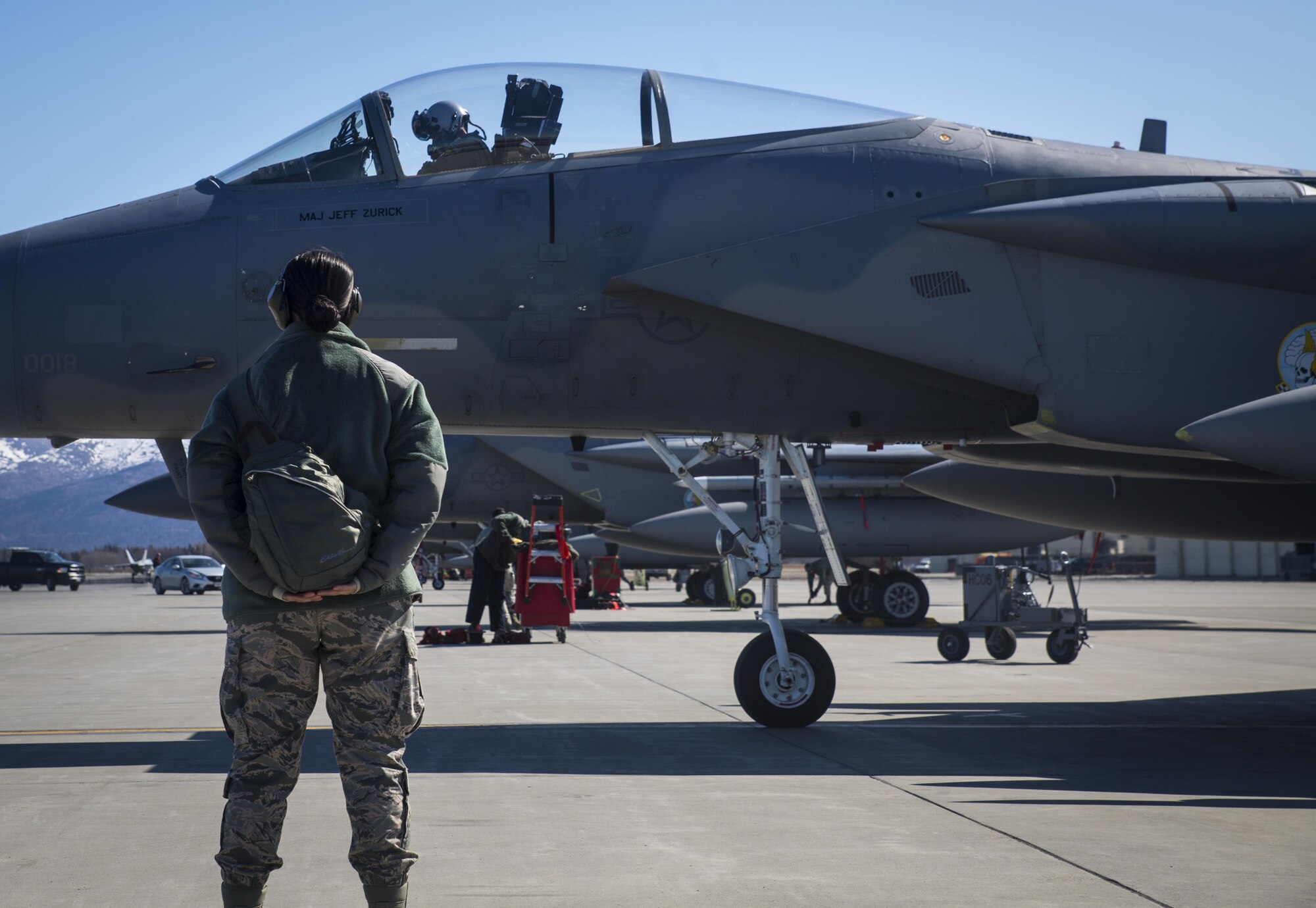 An Airman from the 96th Test Wing based out of Eglin Air Force Base waits for a U.S. Air Force F-15C Eagle pilot to taxi onto the runway at Joint Base Elmendorf-Richardson, Alaska, for exercise Northern Edge 2017, May 5, 2017. This exercise is Alaska’s largest and premier joint training exercise designed to practice operations, techniques and procedures, as well as enhance interoperability among the services. The exercise provides real-world proficiency in detection and tracking of units at sea, in the air and on land and in response to multiple crises in the Indo-Asia-Pacific region. (U.S. Marine Corps photo by Lance Cpl. Andy Martinez)