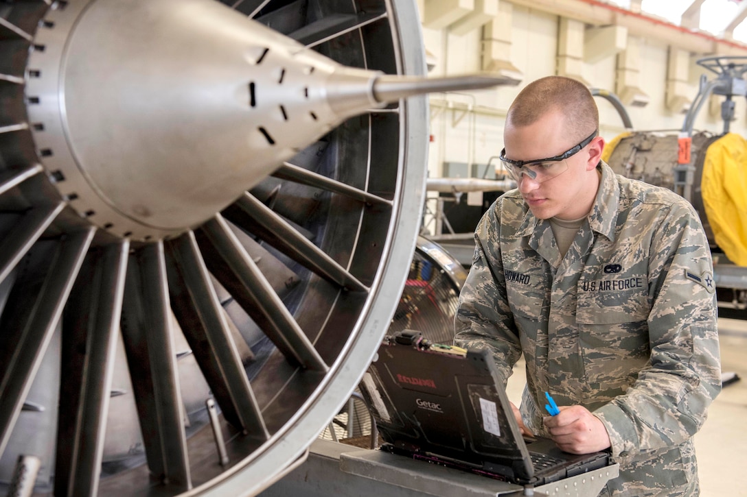 Air Force Airman Travis Howard checks his technical orders before servicing an F-15 Eagle aircraft engine at Kadena Air Base, Japan, May 12, 2017. Howard is an aerospace propulsion technician assigned to the 18th Component Maintenance Squadron. Air Force photo by Senior Airman John Linzmeier