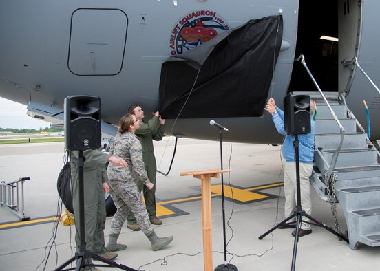 Airman Rebeckah  Eggleston, 3d Airlift Squadron assigned to the squadron aviation resource manager section  and General William Begert (Ret.), former 3d AS commander unveil new nose art on a C-17 Globemaster III during 3d Airlift Squadron 75TH Anniversary Nose Art Unveiling Ceremony May 12, 2017, at Dover Air Force Base, Del. Among those who attended the ceremony were over 150 former squadron members and their families. (U.S. Air Force photo by Mauricio Campino)