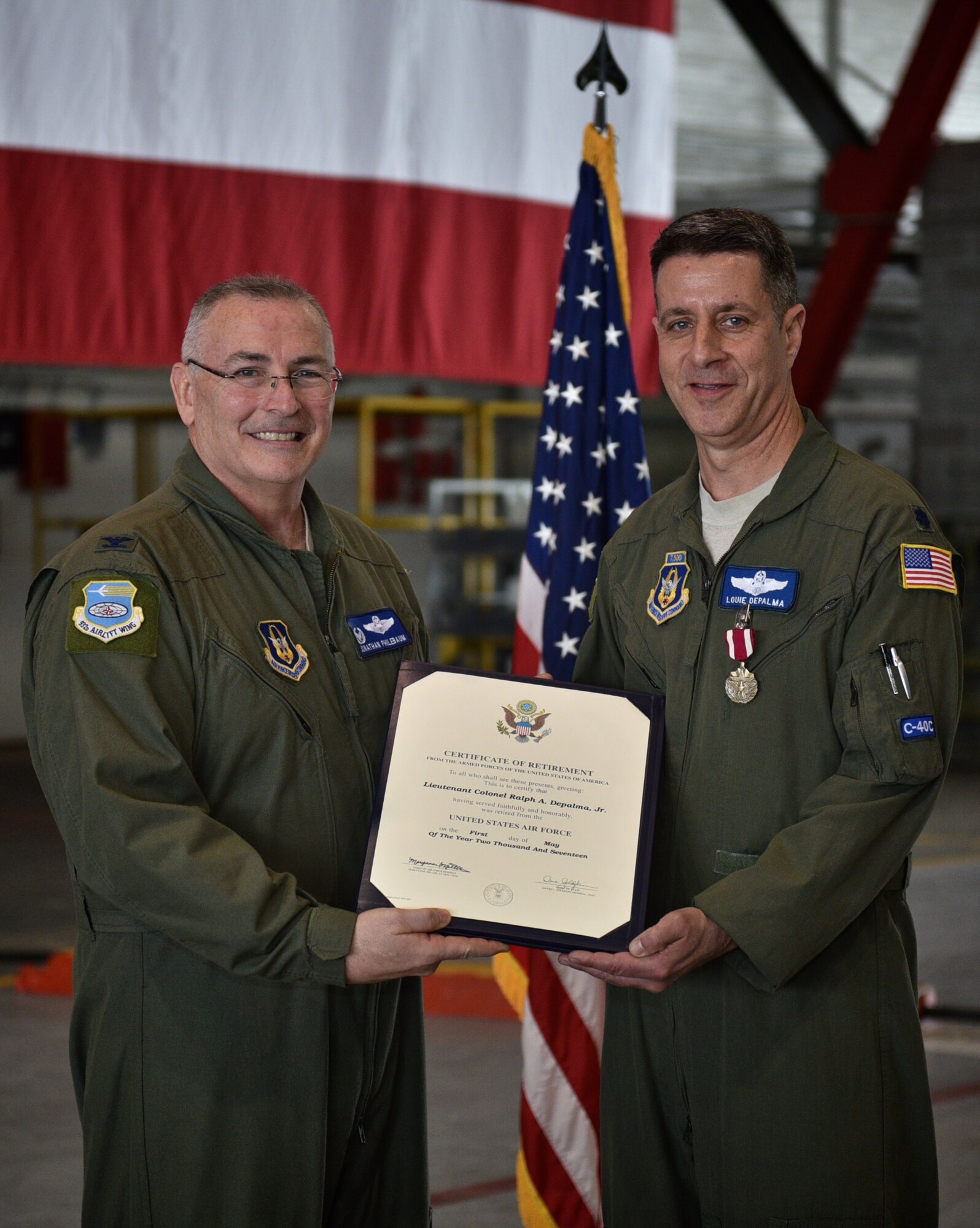 Commander, 932nd Airlift Wing, Col. Jonathan Philebaum, presents Lt. Col. Ralph "Louie" DePalma with his Certificate of Retirement, May 6, 2017 inside Hangar 1, Scott Air Force Base, Illinois. DePalma was the Inspector General for the 932nd as well as a C-40C pilot.  He retires with 30 years of military service in the Air Force. (U.S. Air Force photo by Tech. Sgt. Christopher Parr)