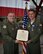 Commander, 932nd Airlift Wing, Col. Jonathan Philebaum, presents Lt. Col. Ralph 