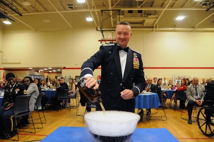 Col. Frederick Thaden, commander of Joint Base McGuire-Dix-Lakehurst, New Jersey, pours an ingredient into the grog bowl during the U.S. Army Reserve’s 99th Regional Support Command dining out May 12 on JBMDL.  The theme of the event was “Veterans: Then and Now.”  More than 100 veterans from area veteran homes were invited to attend.