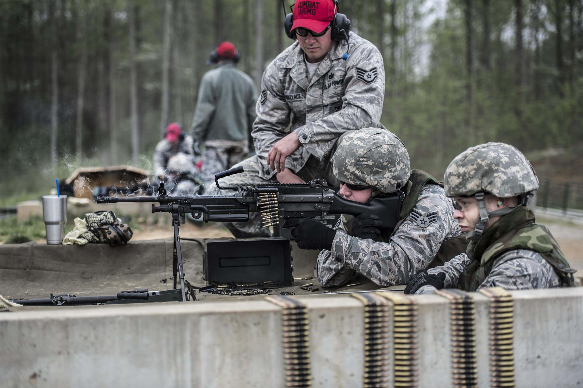 Staff Sgt. Daniel Wallace, 434th Security Forces Squadron Combat Arms instructor, supervises two 434th SFS Airmen qualifying with the M249 squad automatic weapon at Camp Atterbury-Muskatatuk, Ind., April 21, 2017. Grissom Airmen met at the Southern Indiana Army camp to complete their pre-deployment qualifications on multiple weapons systems during a week-long training operation. (U.S. Air Force Photo/Senior Airman Harrison Withrow)
