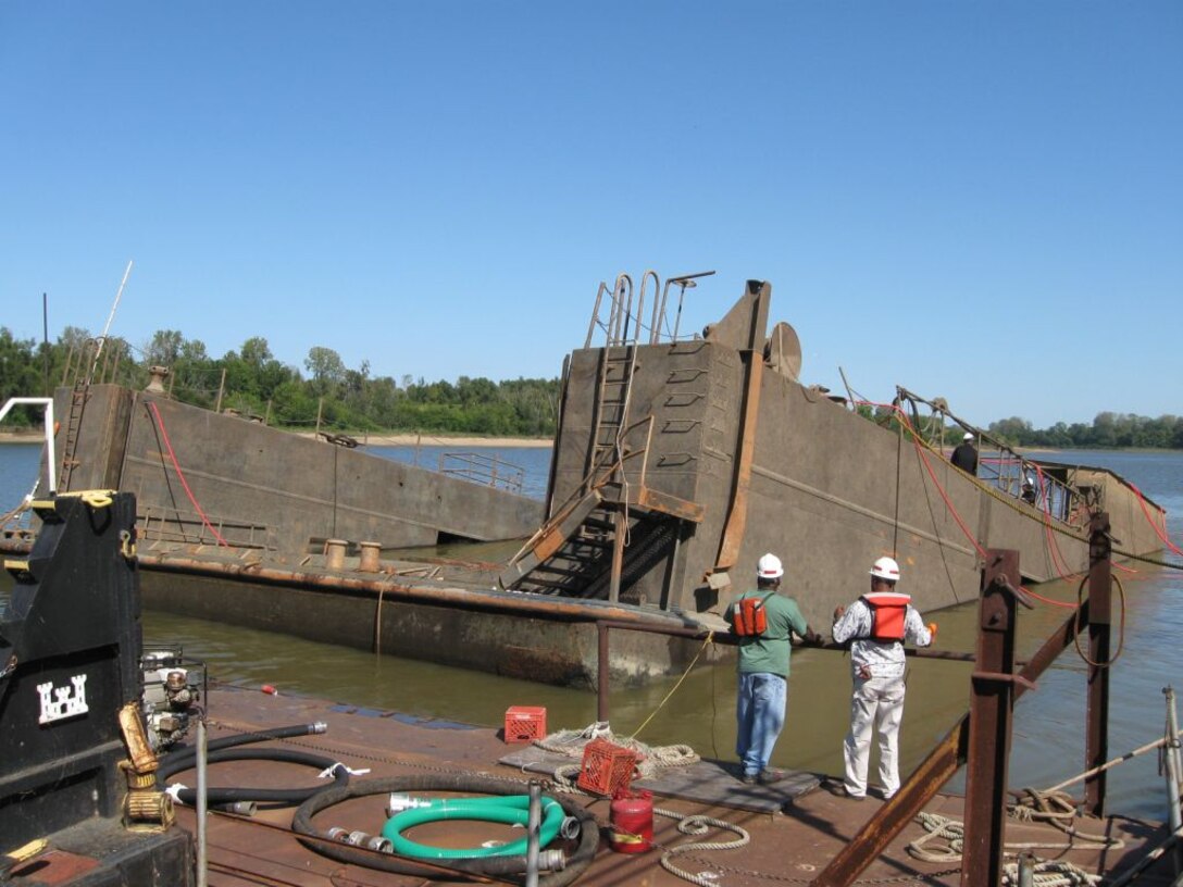 The bow of the Rouse submerged. 

In 2008, the Rouse sank and was almost lost. On Sunday morning, July 20, a security guard noticed that one end of the Rouse’s deck was sinking and alerted District employees. Crew arrived to find the west wall completely submerged. Initially, the crew raised the sinking end, but the dock sank again. The sinking was caused by two leaking valves that allowed water to enter the dock.

In October 2008, the Memphis District partnered with the Nashville District’s Dive Team in an effort to recover the Rouse. The dive team made repairs with the help of EEY technicians who fabricated special parts needed to raise the Rouse.