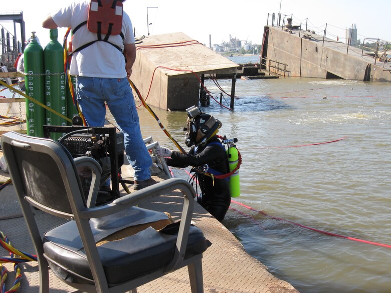 A diver descends into the Mississippi River as part of the Rouse recovery mission.

In 2008, the Rouse sank and was almost lost. 
On Sunday morning, July 20, a security guard noticed that one end of the Rouse’s deck was sinking and alerted District employees. Crew arrived to find the west wall completely submerged. Initially, the crew raised the sinking end, but the dock sank again. The sinking was caused by two leaking valves that allowed water to enter the dock.

In October 2008, the Memphis District partnered with the Nashville District’s Dive Team in an effort to recover the Rouse. The dive team made repairs with the help of EEY technicians who fabricated special parts needed to raise the Rouse.
