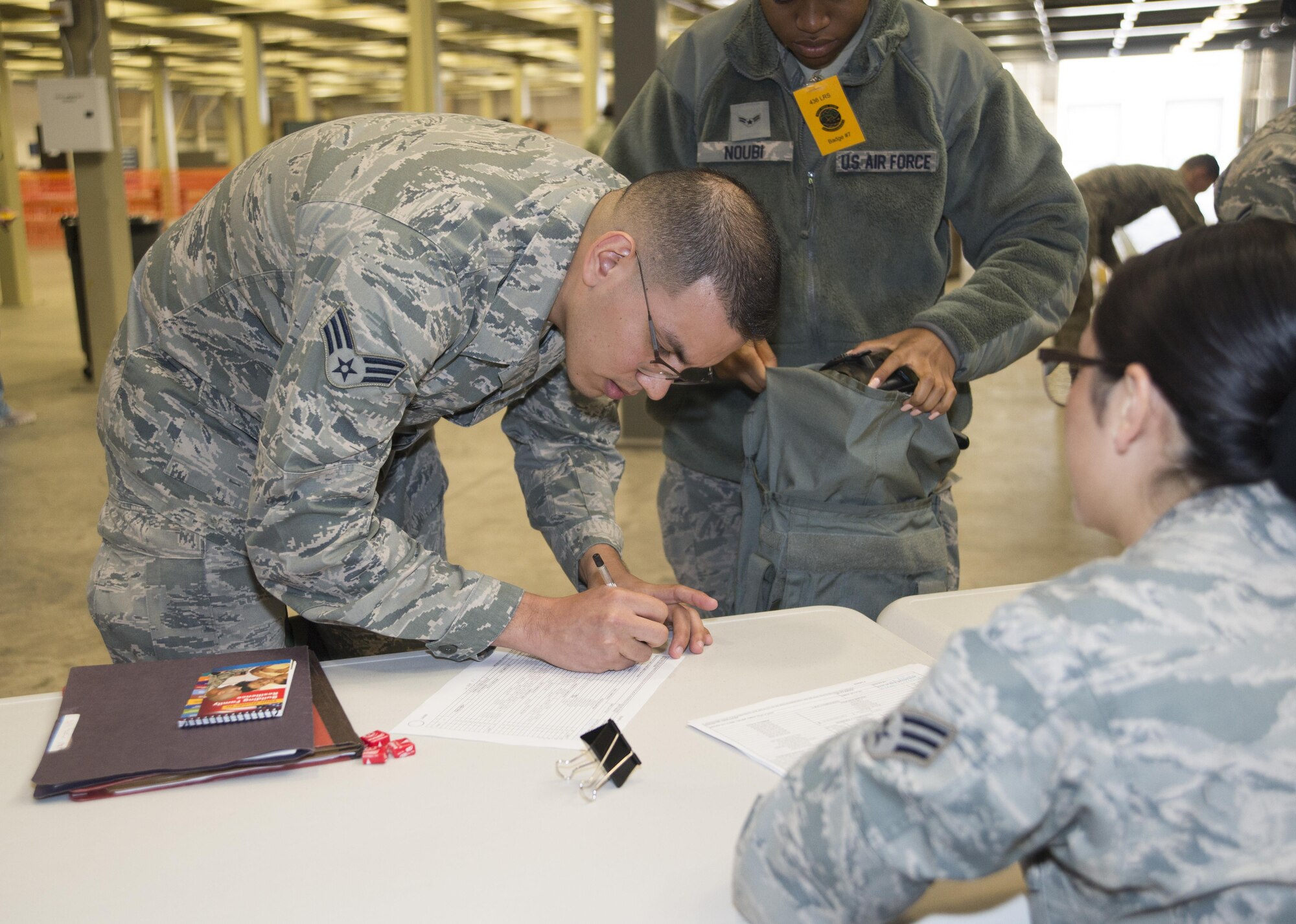 Senior Airman Jose Peña, 436th Logistics Readiness Squadron fleet management and analyses, checks out gear from individual protective equipment during the exercise personal deployment function line May 12, 2017, on Dover Air Force Base, Del. Peña, among many deployers, was issued the gear needed for his deployment during the exercise. (U.S. Air Force photo by Staff Sgt. Jared Duhon)