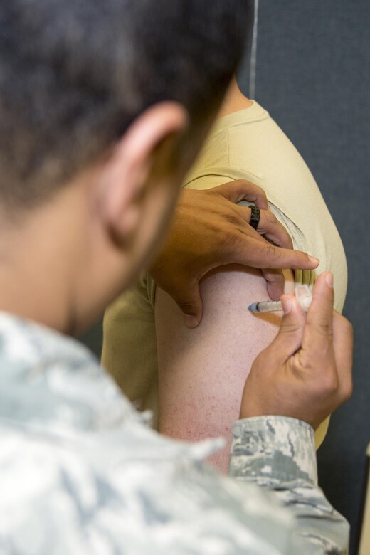 Staff Sgt Justin Wright, 436th Logistics Readiness Squadron supply supervisor, receives an anthrax vaccine during the exercise personal deployment function line May 12, 2017, on Dover Air Force Base, Del. Wright was one of many deployers who were due for shots and were able to get them from medical on the line. (U.S. Air Force photo by Staff Sgt. Jared Duhon)