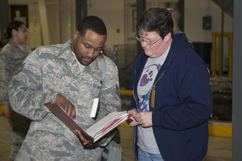 Tech. Sgt Randie Page, 436th Aerial Port Squadron travel management office air transportation standardization and evaluations program evaluator, talks with Sandra Rivera, 436th Logistics Readiness Squadron supply technician, during the exercise personal deployment function line May 12, 2017, on Dover Air Force Base, Del. Deployers during the PDF line were issued different items depending on where they were going, which is what Rivera was helping Page with. (U.S. Air Force photo by Staff Sgt. Jared Duhon)