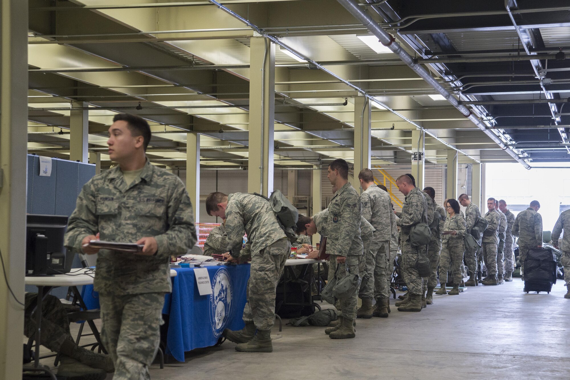 Team Dover deployers process different functions of the military personal section during the exercise personal deployment function line May 12, 2017, on Dover Air Force Base, Del. The offices that were available at the exercise PDF line are all support elements that would be available if these deployers were leaving the day of, which include legal, finance and chapel to name a few. (U.S. Air Force photo by Staff Sgt. Jared Duhon)