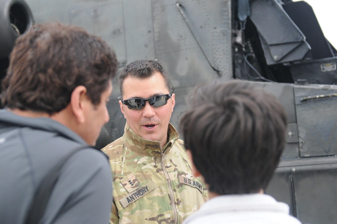 Guardsman Chief Warrant Officer 3 Gregory Anthony, an attack helicopter instructor pilot, for the 2nd Infantry Brigade Combat Team out of Johnstown, Pa., speaks with spectators during the Wings Over Pittsburgh 2017 Air Show at the 911th Airlift Wing in Coraopolis, Pa., May 13, 2017. The air show was held May 13-14 and provided visitors a chance to speak face-to-face with pilots and other military personnel from the 911th Airlift Wing and the 171st Air Refueling Wing.