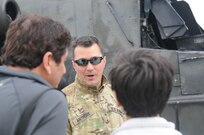 Guardsman Chief Warrant Officer 3 Gregory Anthony, an attack helicopter instructor pilot, for the 2nd Infantry Brigade Combat Team out of Johnstown, Pa., speaks with spectators during the Wings Over Pittsburgh 2017 Air Show at the 911th Airlift Wing in Coraopolis, Pa., May 13, 2017. The air show was held May 13-14 and provided visitors a chance to speak face-to-face with pilots and other military personnel from the 911th Airlift Wing and the 171st Air Refueling Wing.