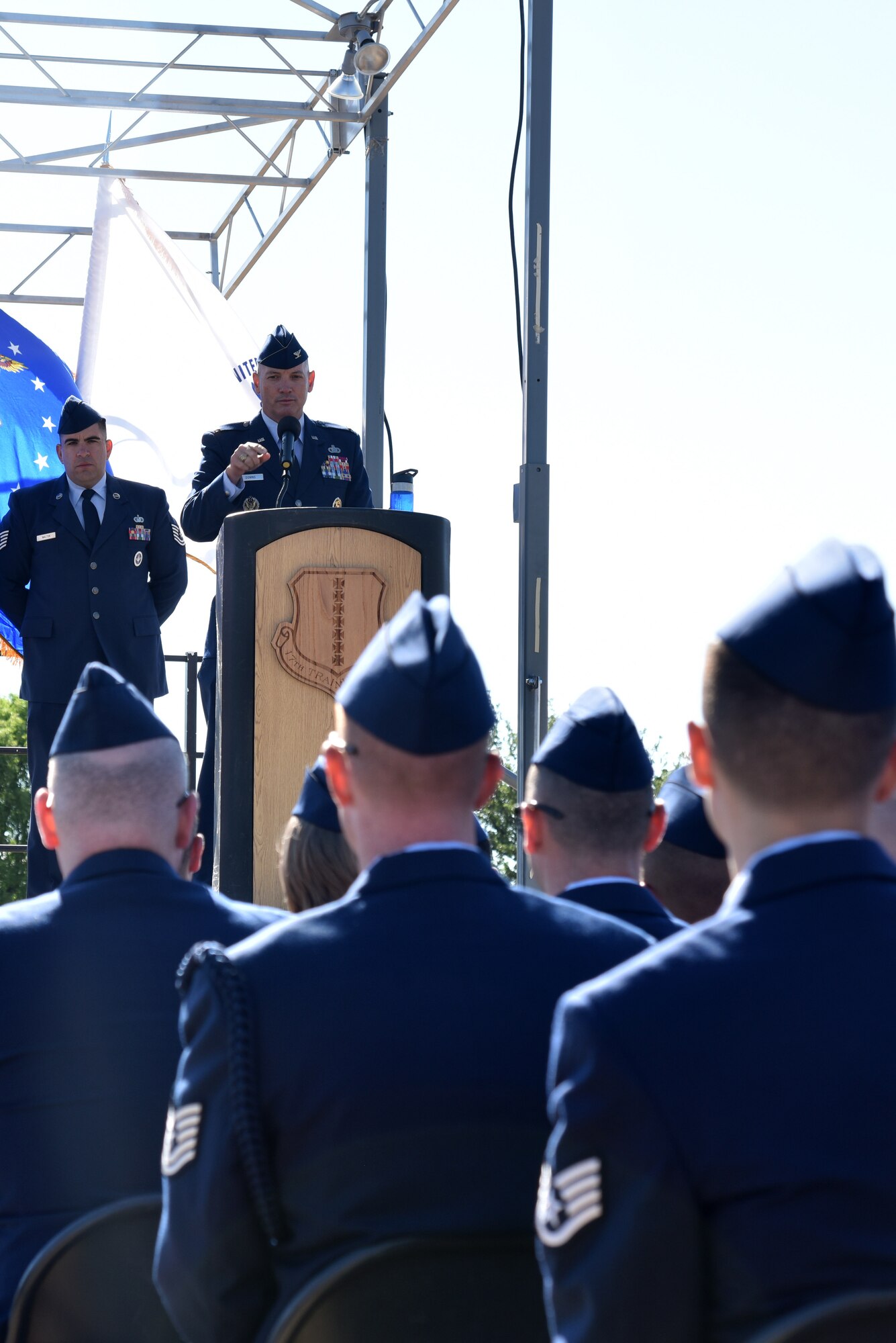 U.S. Air Force Col. Michael Downs, 17th Training Wing commander, speaks at the Community College of the Air Force graduation at the parade field on Goodfellow Air Force Base, Texas, May 12, 2017. During his speech, Downs highlighted Airmen that completed their CCAF under special circumstances such as working a second job. (U.S. Air Force photo by Staff Sgt. Joshua Edwards/Released)