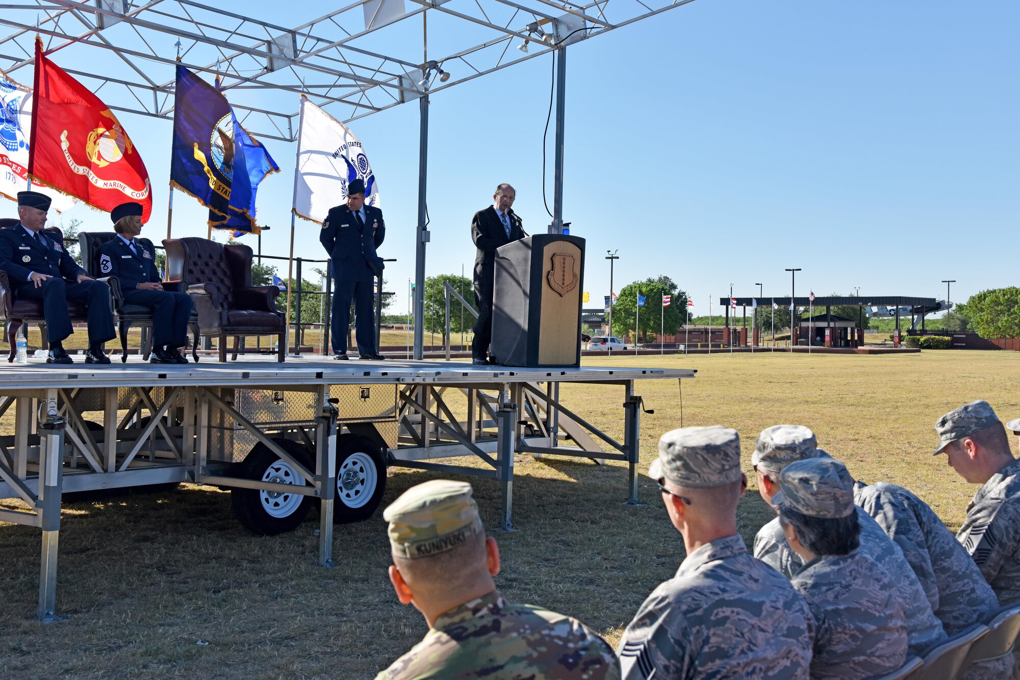 U.S. Air Force Retired Chief Master Sgt. Ed Bendinelli, Community College of the Air Force graduation guest speaker, speaks at the CCAF graduation at the parade field on Goodfellow Air Force Base, Texas, May 12, 2017. Bendinelli spoke about how an education can open possibilities. (U.S. Air Force photo by Staff Sgt. Joshua Edwards/Released)