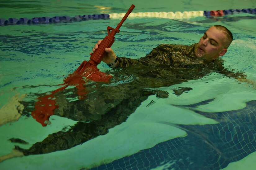 U.S. Air Force Tech. Sgt. George Daggett, 633rd Security Forces Squadron swing shift flight chief, performs a recovery swim during a training evolution at Joint Base Langley-Eustis, Va., April 28, 2017. The 633rd SFS Emergency Services Team conducted a test trial for a course future candidates will have to accomplish in order to join the EST ranks. (U.S. Air Force photo/Senior Airman Derek Seifert)