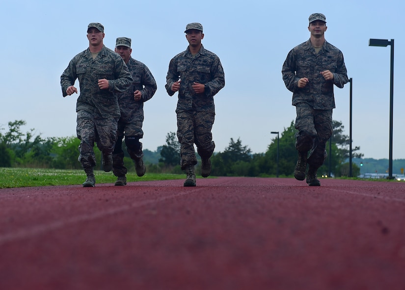 Members of the 633rd Security Forces Emergency Services Team runs after finishing a water confidence evolution at Joint Base Langley-Eustis, Va., April 28, 2017. The team conducted water confidence training, completed a modified Marine Combat Fitness Test, a ruck march and weapons and tactics drills to develop a baseline for future candidates who want to join the EST. (U.S. Air Force photo/Senior Airman Derek Seifert)