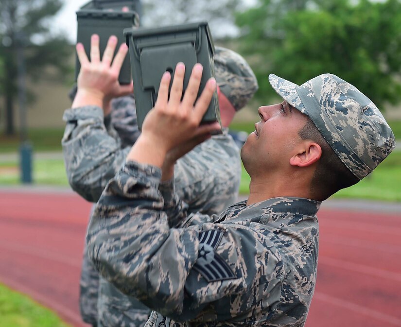 U.S. Air Force Staff Sgt. Daniel Corral, 633rd Security Forces Squadron training instructor, performs a timed ammunition box lift at Joint Base Langley-Eustis, Va., April 28, 2017. Corral and members of the 633rd SFS Emergency Services Team developed and tested a qualification course which will be used for future candidates who want to join the EST. (U.S. Air Force photo/Senior Airman Derek Seifert)