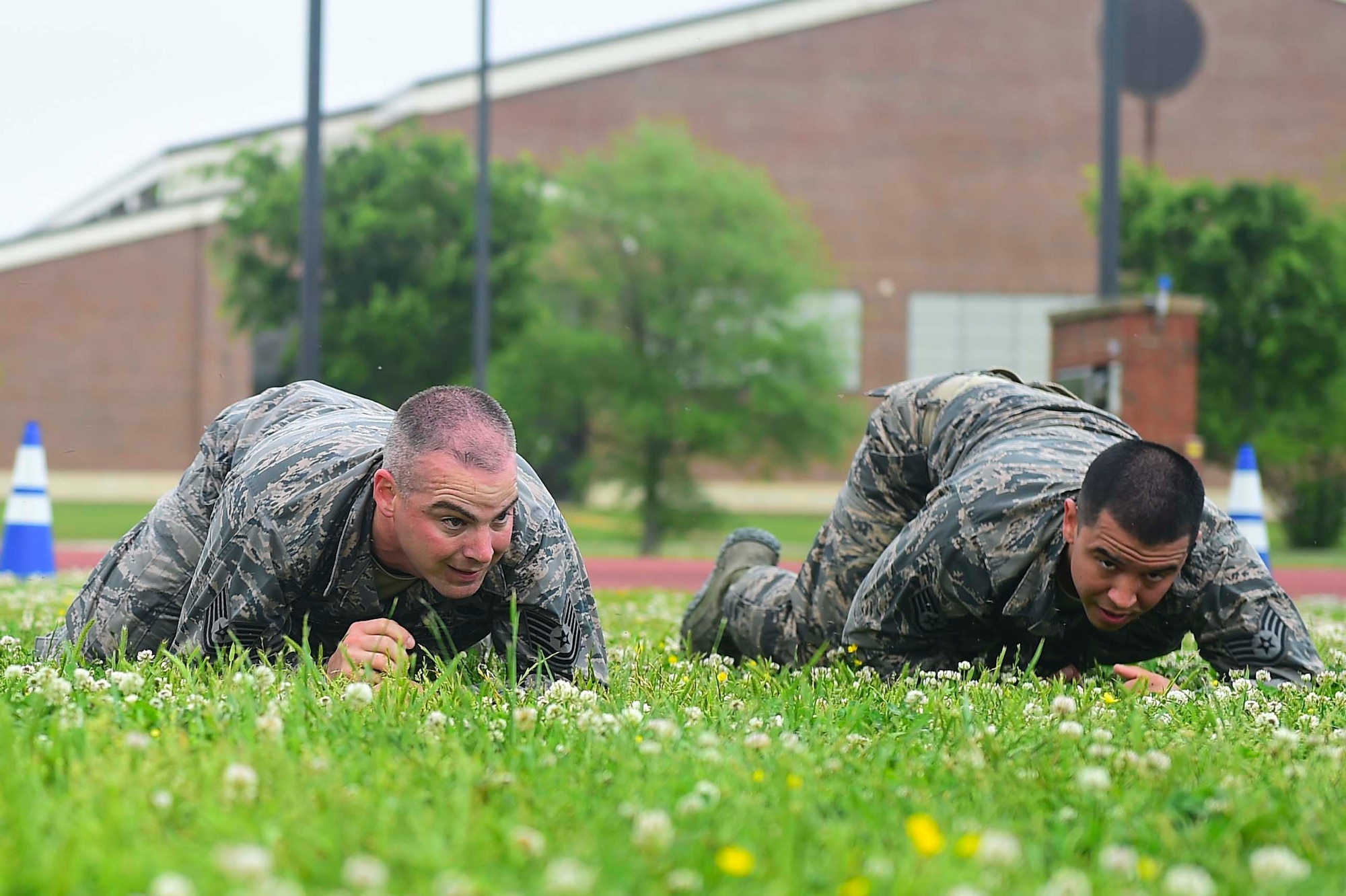 Members of the 633rd Security Forces Squadron Emergency Services Team perform a high crawl during a modified Marine Combat Physical Test at Joint Base Langley-Eustis, Va., April 28, 2017. The team provide services equal to a civilian police SWAT (Special Weapons and tactics) Team , to the installation and train to handle hostage and barricaded suspect situations. (U.S. Air Force photo/Senior Airman Derek Seifert)