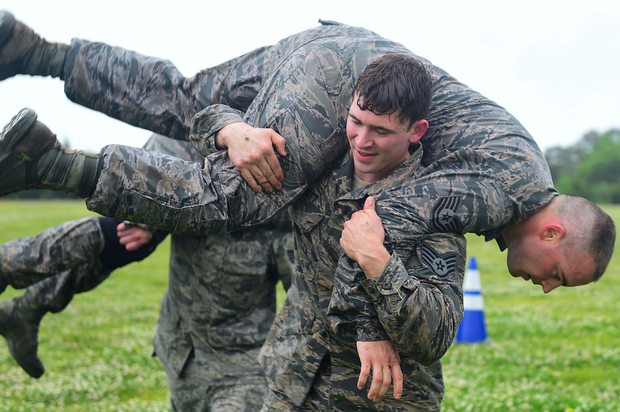 U.S. Air Force Staff Sgt. Gary Good, 633rd Security Forces Squadron unit trainer, performs a buddy carry during a modified Marine Combat Fitness Test at Joint Base Langley-Eustis, Va., April 28, 2017. During the modified Marine Combat Physical Test, Good and his fellow members of the 633rd SFS Emergency Services Team performed a low crawl, high crawl and a fireman carry. (U.S. Air Force photo/Senior Airman Derek Seifert)