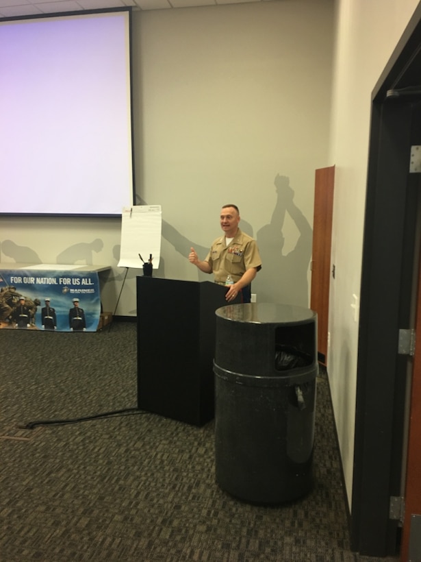 Colonel Jason Morris speaks to a group of university wrestling coaches and leaders, today, about the values Marines and wrestlers share during the NWCA leadership academy in Edwardsville, Illinois. He talked about the three missions of the U.S. Marine Corps - make Marines, win our nation’s battles and develop quality citizens - and spoke about how to adapt them so the coaches in attendance could grow wrestling. His speech focused on how training is the most important part of a leader’s job, whether it is preparing a team for battle or the wrestling mat.