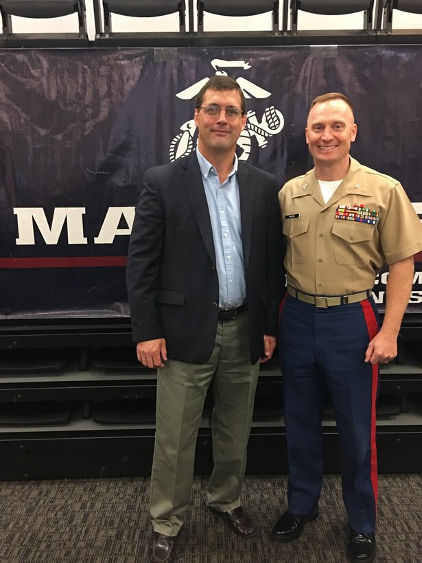 Colonel Jason Morris speaks to a group of university wrestling coaches and leaders, today, about the values Marines and wrestlers share during the NWCA leadership academy in Edwardsville, Illinois. He talked about the three missions of the U.S. Marine Corps - make Marines, win our nation’s battles and develop quality citizens - and spoke about how to adapt them so the coaches in attendance could grow wrestling. His speech focused on how training is the most important part of a leader’s job, whether it is preparing a team for battle or the wrestling mat.