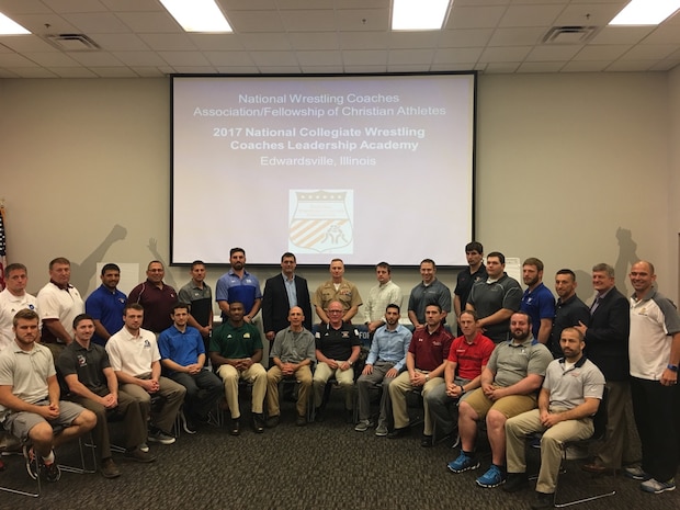 Colonel Jason Morris speaks to a group of university wrestling coaches and leaders, today, about the values Marines and wrestlers share during the NWCA leadership academy in Edwardsville, Illinois. He talked about the three missions of the U.S. Marine Corps - make Marines, win our nation’s battles and develop quality citizens - and spoke about how to adapt them so the coaches in attendance could grow wrestling. His speech focused on how training is the most important part of a leader’s job, whether it is preparing a team for battle or the wrestling mat.