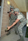 Security forces defenders from the 502nd Security Readiness Group at Joint Base San Antonio  practice tactical approach maneuvers during  May 4, 2017, at Joint Base San Antonio-Camp Bullis. Security forces Airmen and members of local police departments  participated in a 5-day Special Weapons and Tactics (SWAT) training course taught by members of the Alamo Area Council of Governments Regional Law Enforcement Academy, which aims to strengthen incident response techniques and build effective law enforcement teams. Officers certified as trainers from police departments around San Antonio area teach the course, which serves as both a refresher course for defenders and an opportunity to foster partnerships between local law enforcement members and JBSA defenders. (U.S. Force photo by Andrew C. Patterson) 