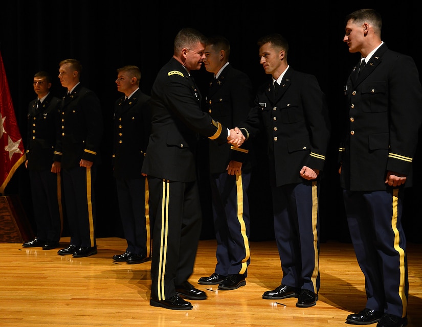 U.S. Army Gen. David Perkins, commanding general of U.S. Army Training and Doctrine Command, congratulates newly commissioned second lieutenants during a Commissioning Ceremony at the College of William & Mary in Williamsburg, Va., May 12, 2017. During the ceremony, family members pinned the rank onto the newly commissioned lieutenants, and per tradition they presented a silver coin to an enlisted member, rendering their first salute. (U.S. Air Force photo/Staff Sgt. Teresa J. Cleveland)