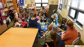 Children and parents listen to a book reading at the Joint Base Elmendorf-Richardson Library, Alaska, April 28, 2017. The Library Summer Reading Program is a way to keep children reading over the summer to help prevent loss of reading skills. 