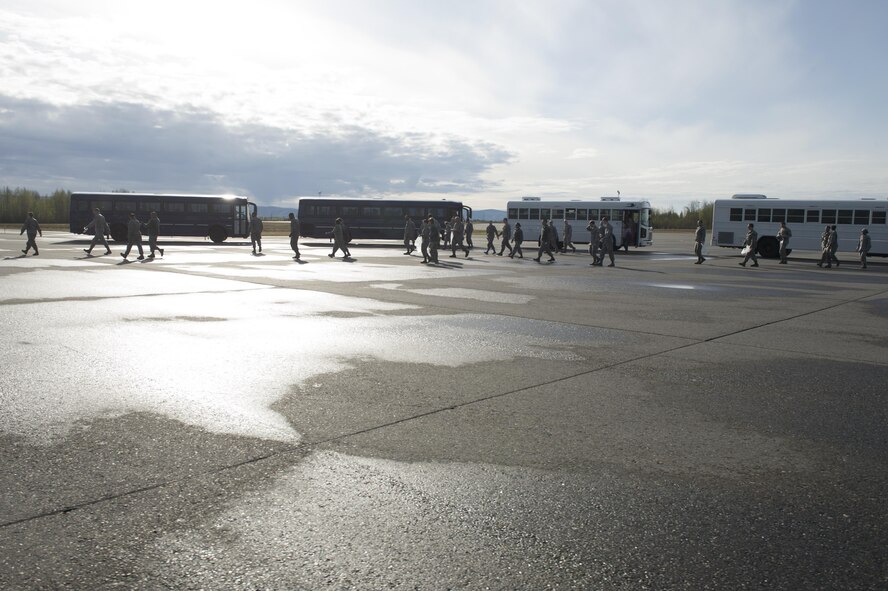U.S. Air Force Airmen from the 354th Fighter Wing, depart buses on the flightline to assist with a foreign object debris (FOD) walk, May 15, 2017, at Eielson Air Force Base, Alaska. The Icemen Team worked together to ensure five and half miles of taxiways and runways were clear of debris. (U.S. Air Force photo by Airman Eric M. Fisher)