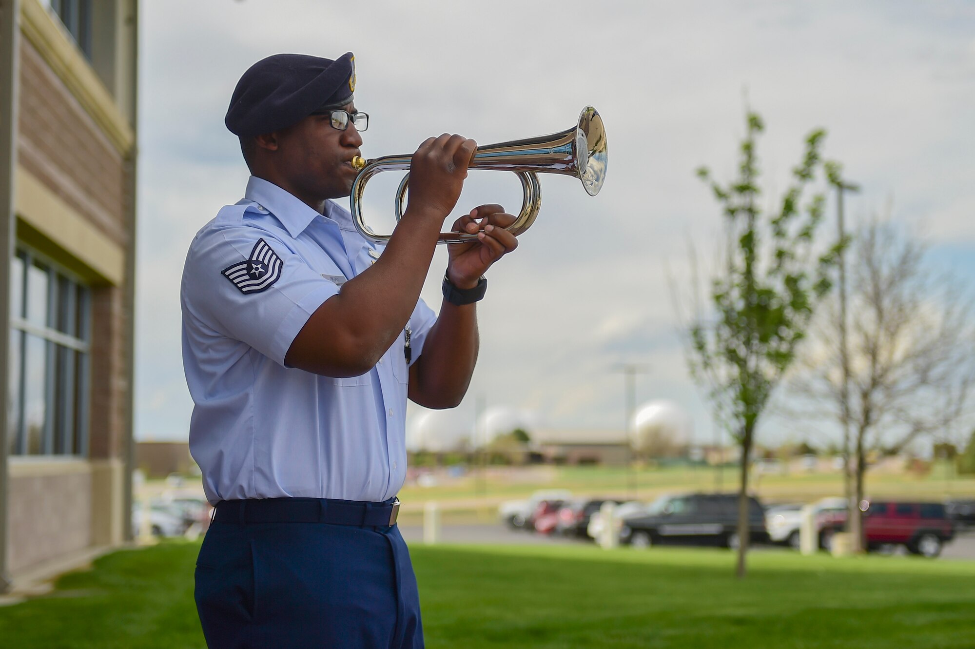 Tech. Sgt. Brandon Dinkins, 460th Security Forces Squadron trainer, plays TAPS during the Retreat ceremony May 15, 2017, on Buckley Air Force Base, Colo. The Retreat ceremony recognizes fallen civilian and military law enforcement officers with the 21-gun salute, the playing of TAPS and the National Anthem. (U.S. Air Force photo by Airman Jacob Deatherage/Released)