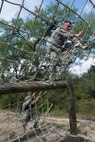Members of the 802nd and 902 Security Forces Squadrons compete in the Obstacle Course Team Challenge May 15, 2017, at Joint Base San Antonio-Lackland, Texas Medina Annex. The event was held as part of National Police Week, an annual celebration to honor the service and sacrifice of law enforcement members and pays special tribute to law enforcement officers who have lost their lives in the line of duty for the safety and protection of others. JBSA security forces members participated participate in events weeklong May 15-19 across the installations. (U.S. Air Force photo by Staff Sgt. Marissa Garner)