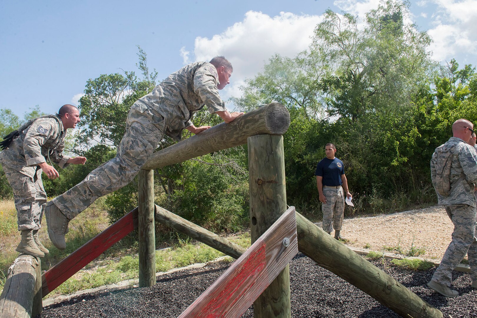 Members of the 802nd and 902 Security Forces Squadrons compete in the Obstacle Course Team Challenge May 15, 2017, at Joint Base San Antonio-Lackland, Texas Medina Annex. The event was held as part of National Police Week, an annual celebration to honor the service and sacrifice of law enforcement members and pays special tribute to law enforcement officers who have lost their lives in the line of duty for the safety and protection of others. JBSA security forces members participated participate in events weeklong May 15-19 across the installations. (U.S. Air Force photo by Staff Sgt. Marissa Garner)