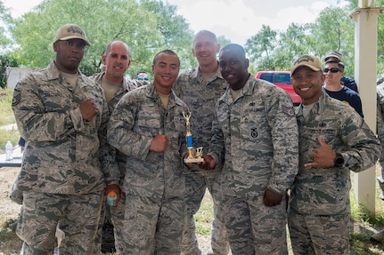Members of the 343rd Training Squadron accept their second place trophy after competing in the Obstacle Course Team Challenge May 15, 2017, at Joint Base San Antonio-Lackland, Texas, Medina Annex. The event was held as part of National Police Week, an annual celebration to honor the service and sacrifice of law enforcement members and pays special tribute to law enforcement officers who have lost their lives in the line of duty for the safety and protection of others. JBSA security forces members participated participate in events weeklong May 15-19 across the installations. (U.S. Air Force photo by Staff Sgt. Marissa Garner)