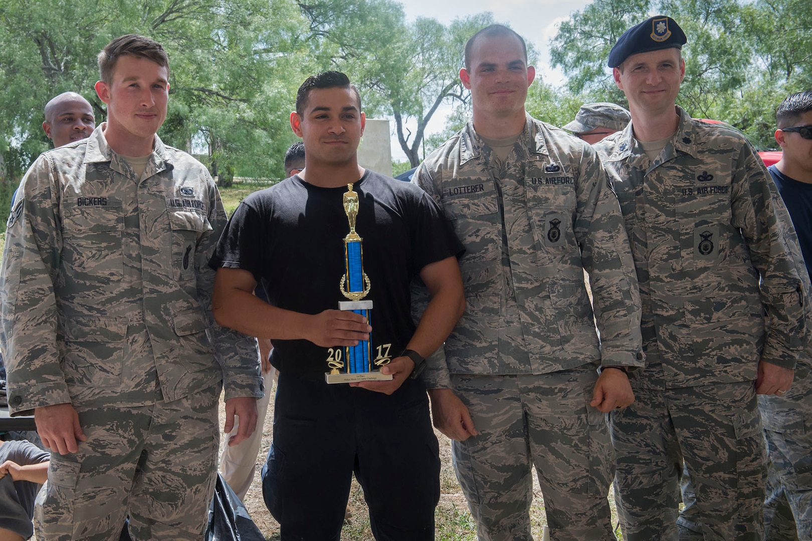 Members of the 343rd Training Squadron accept their first place trophy after competing in the Obstacle Course Team Challenge May 15, 2017, at Joint Base San Antonio-Lackland, Texas, Medina Annex. The event was held as part of National Police Week, an annual celebration to honor the service and sacrifice of law enforcement members and pays special tribute to law enforcement officers who have lost their lives in the line of duty for the safety and protection of others. JBSA security forces members participated participate in events weeklong May 15-19 across the installations. (U.S. Air Force photo by Staff Sgt. Marissa Garner)